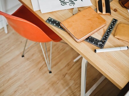a wooden table with rulers on it